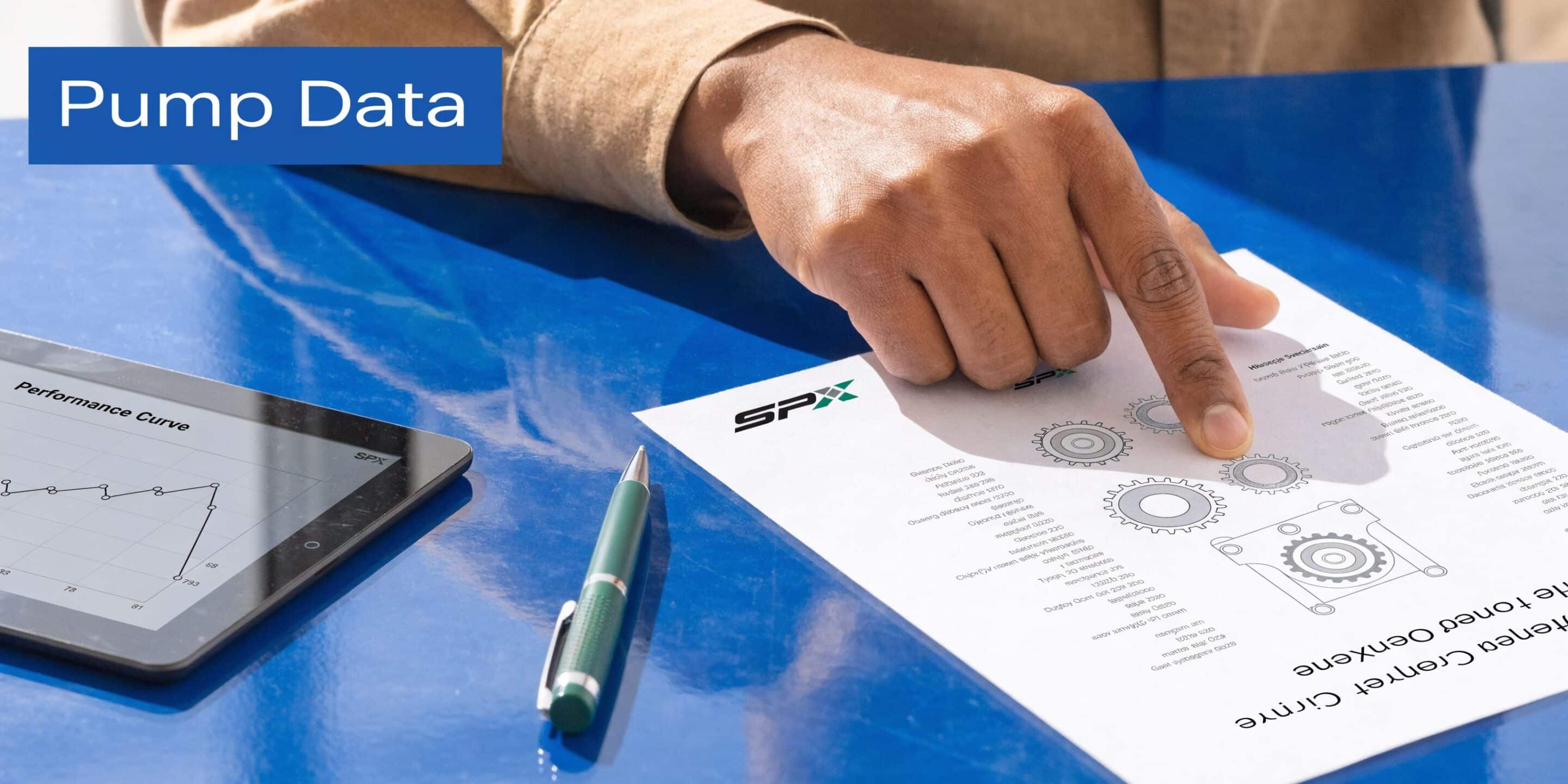 A hand pointing at technical gear diagrams on a document next to a digital performance curve tablet.