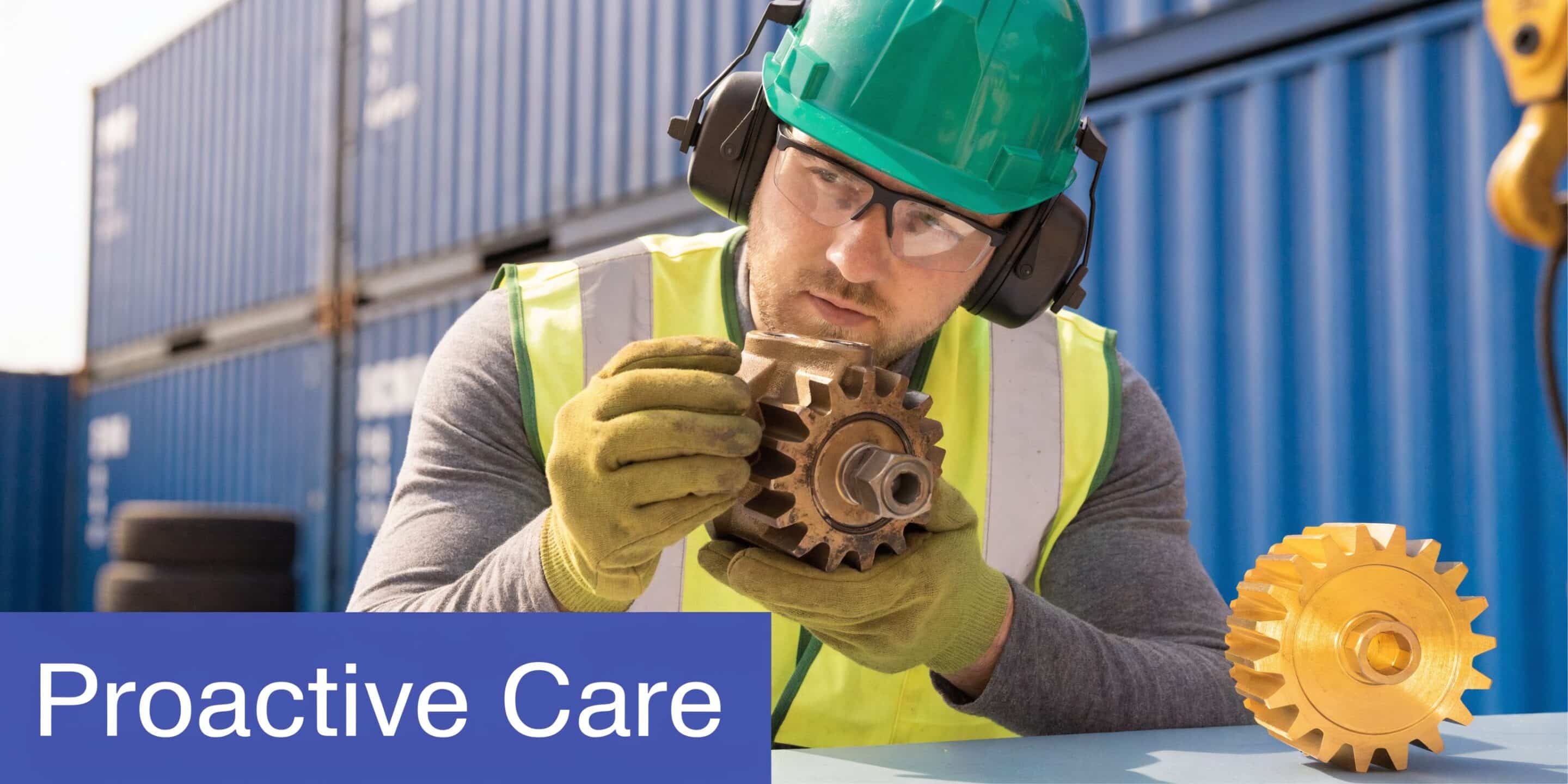 A maintenance technician wearing a helmet and high-visibility vest inspects a industrial gear hydraulic pump part.